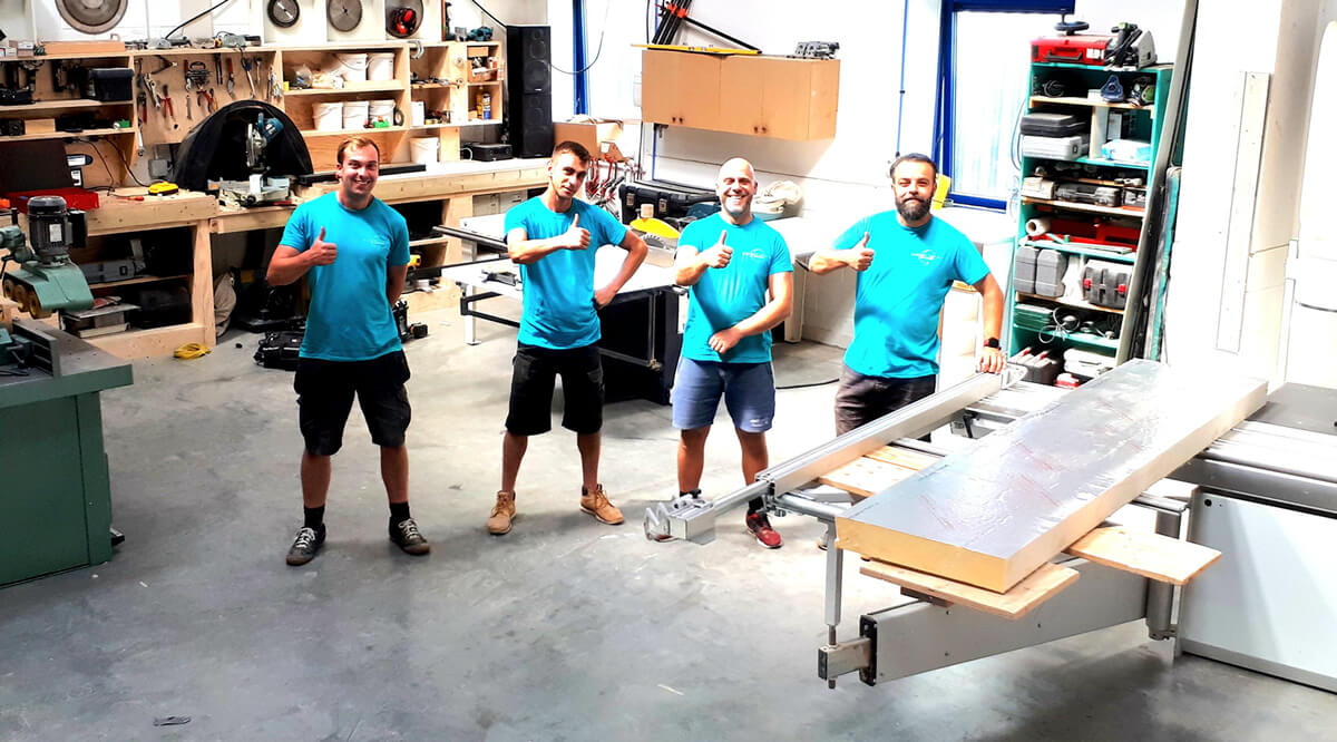 Happy staff in the workshop at Garden Rooms by Drumbeat, Surrey